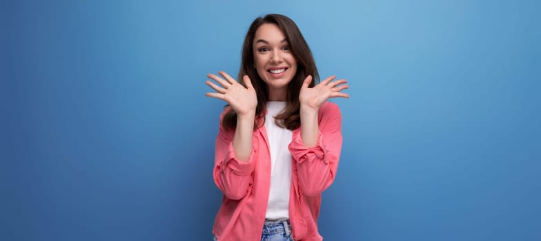 panoramic photo of a long haired brunette young adult in a shirt with cheerful emotions on an isolated background