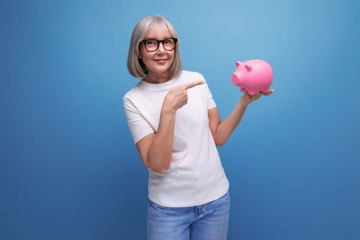 grandmother with gray hair thinks where to invest her savings on a studio background with copy space