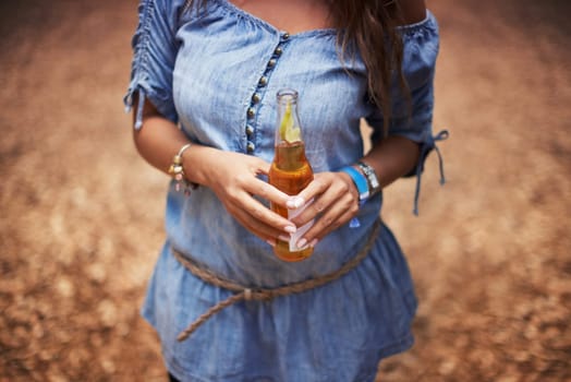 Hands of woman at music festival with nature, beer and relax in woods for concert event. Alcohol, celebration and girl at outdoor party in freedom, adventure and person in park, forest or countryside