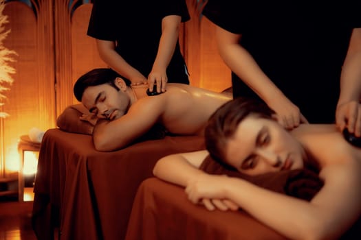 Hot stone massage at spa salon in luxury resort with warm candle light.Quiescent