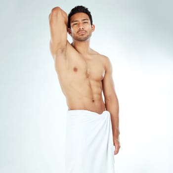 Shower, towel and portrait of asian man body in studio for wellness, cosmetics or cleaning on white background. Bathroom, face and Japanese male model with confidence, attitude or spa aesthetic pose.
