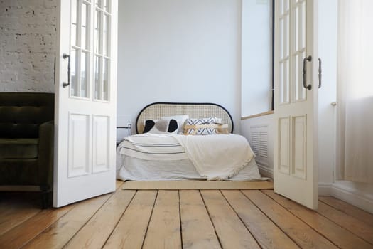 Bedroom interior with wooden floor and white walls