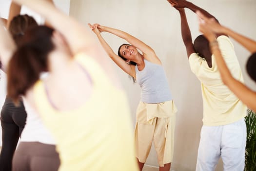 Stretching, yoga and group with personal trainer for class balance, exercise and workout together. Pilates, health club and men and women with instructor for wellness, fitness and healthy body