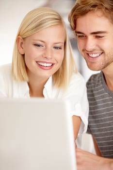 Laptop, smile and love with a young couple in their apartment for planning or investing together. Computer, online or ecommerce with a happy man and woman in the home for portfolio, website or growth.