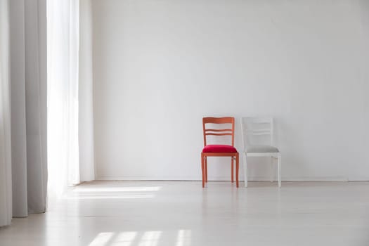 Two old vintage chairs in white room interior