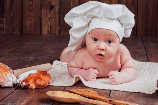 baby Cook lies on the table bread bread flour