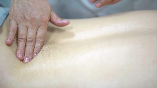 Close-up of man receiving back massage in spa salon. Spa treatment