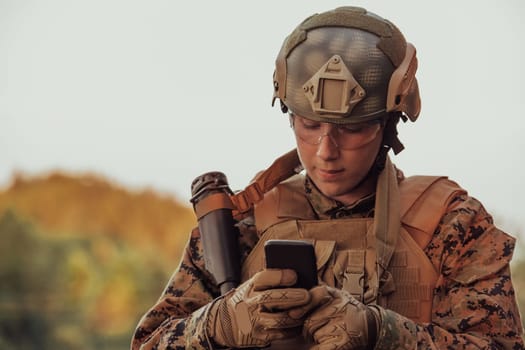 Soldier using smartphone to contact family or girlfriend communication and nostalgia concept