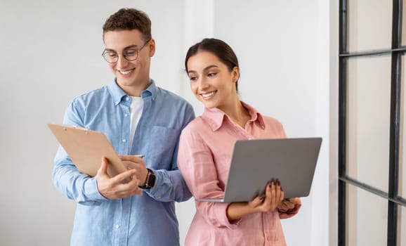 Glad professional confident millennial diverse people work with tablet, computer planning finance