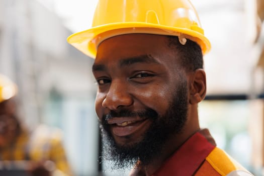 Smiling african american handyman wearing yellow hard hat portrait