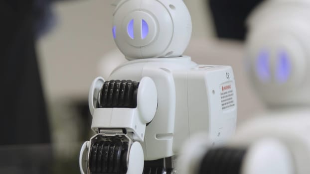 SHANGHAI - JUNE 28 2018: A small robot with human face and body - humanoid. Closeup of an cute autonomous service robot. Close-up of robot head