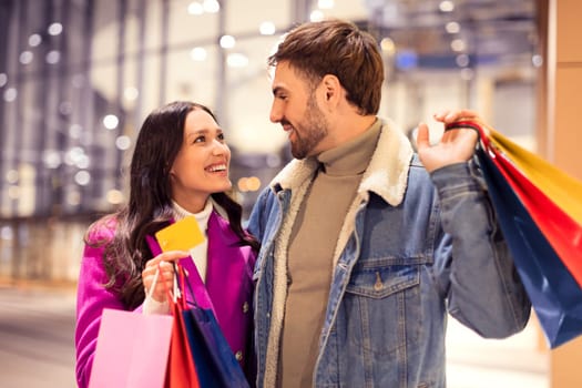 Lady shows credit card to man to start winter shopping
