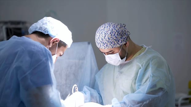 Surgeons cauterize wounds. Action. Professional surgeons carry out concentration operation under anesthesia with use of modern technologies. Surgeons cauterize open wounds