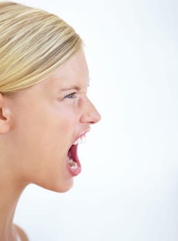 Angry face, profile or woman screaming in studio at mockup space for crisis, mad emoji or reaction on white background. Frustrated model, voice and shouting loud in anger, negative expression or rage