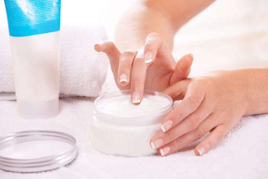 Woman, hands and cream for skincare, cosmetics or beauty products in salon or spa treatment. Closeup of female person with jar or container of lotion, SPF or creme for soft skin or moisturizer