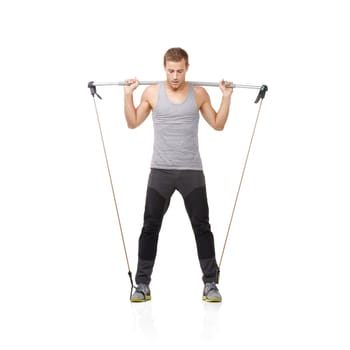 Gym, workout and resistance band with a young man in studio isolated on a white background for health. Fitness, exercise or performance and a strong athlete training with equipment for wellness