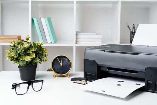 Workplace with modern printer and clock in the office