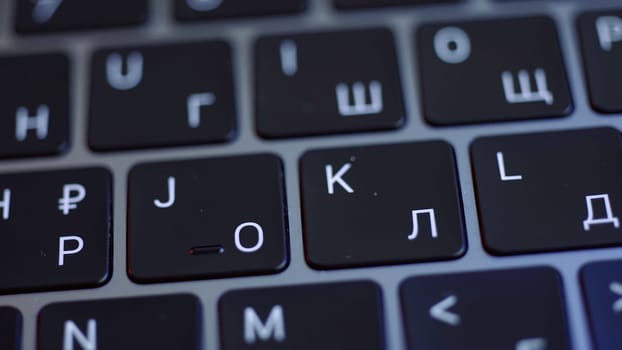 Close up of the keyboard of a laptop in black and white colors. Action. Concept of modern computer technologies, laptop keypad with glowing letters.