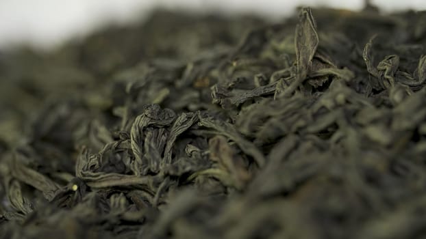 Dry tea, dried leaves. Black tea leaves background. dry leaf green tea on a white background. Pile of dry tea, close up