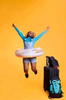 Joyful woman travelling abroad with bags