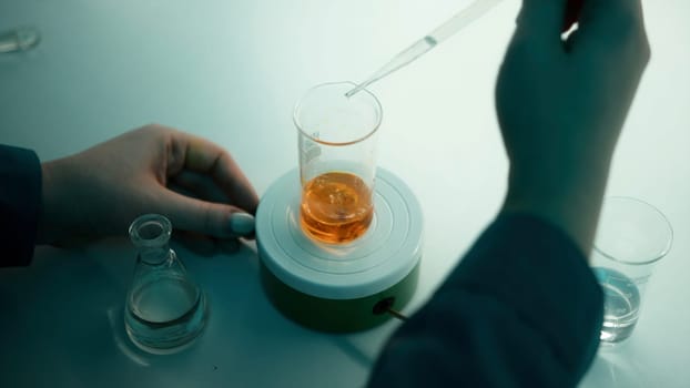 Science or medical lab research test in the laboratory. Stock footage. Mixture in a flask.