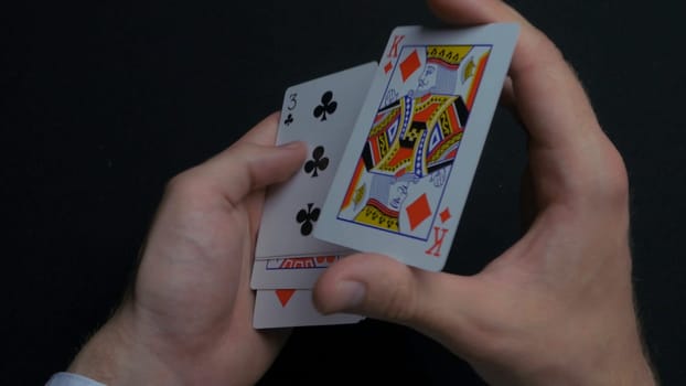 Poker game - shuffling cards. Man's hands shuffing cards. Close up. Man's hands shuffling playing cards. Dealer's hands shuffling cards during a poker game