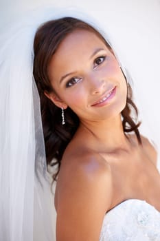 Portrait, smile and a woman at her wedding for love, marriage or an event of tradition in celebration of commitment. Face, beauty and elegance with a happy young bride getting married at a ceremony