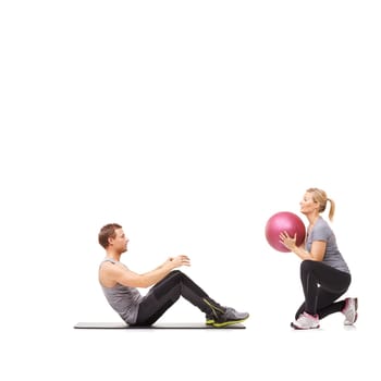 Coaching, man and woman with gym ball for pilates in studio, body fitness and support. Sports workout, fit girl and personal trainer with sphere for balance, training and power on white background.