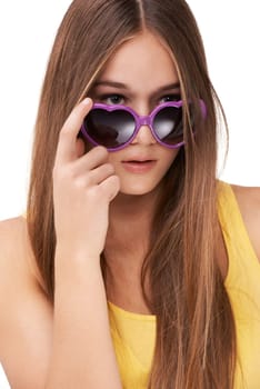 Woman, fashion and heart shape glasses with hair style, cool or looking isolated against a white studio background. Face of female person, brunette or model posing with sunglasses in casual stare