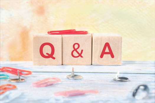 Q and A signs on wooden cubes on a light background