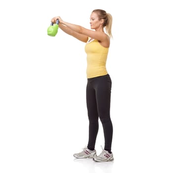 Exercise, workout and studio woman with kettlebell swing for muscle growth, strong arm strength or weightlifting. Fitness club equipment, wellness commitment and girl bodybuilding on white background