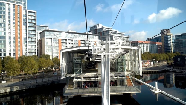 Modern cable car with cabins in city. Action. Cable car with beautiful view of modern city with beautiful architecture and landscape