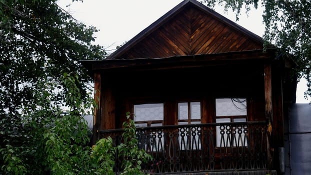 Exterior of a wooden house in the countryside. Stock footage. Traditional residential house with wooden walls.