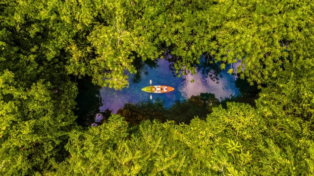 couple in kayak in the jungle of Krabi Thailand, men and woman in kayak at a tropical jungle in Krabi mangrove forrest