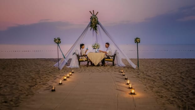Romantic dinner on the beach, honeymoon dinner on the beach during sunset Thailand, valentine setting