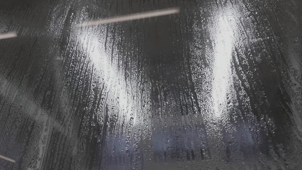 Water drops on glass. Drops of rain on a black glass background. Natural Pattern of raindrops. Rain in the city. Effect from raindrop make vapor on the window