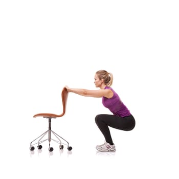 Pilates, exercise and woman squat with chair or crouch in white background or studio. Stretching, body and person in workout with a seat for fitness, health and wellness practice for posture