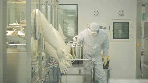 Pharmaceutical industry. Male factory worker inspecting quality of pills packaging in pharmaceutical factory. Automatic tape to create packaging and filling of medicines. control in the factory of medicine.