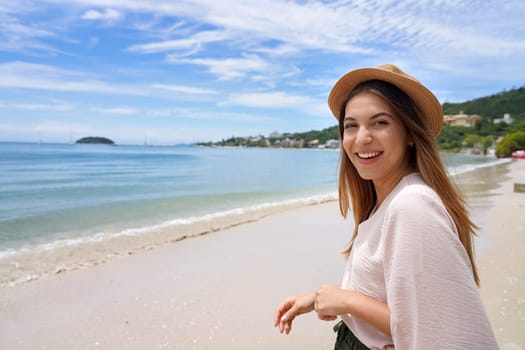 Portrait of cheerful stylish young woman on Jurere beach, Florianopolis, Santa Catarina Island, Brazil. Copy space. 