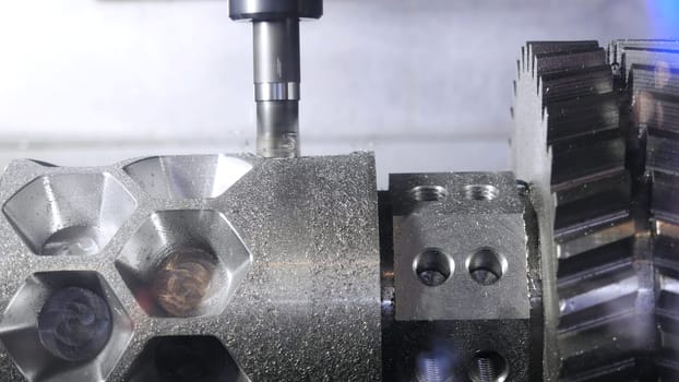Metalworking cutting process by milling cutter. Media. CNC machine processes metal detail. Close-up of the metal workpiece processing on the latest machine