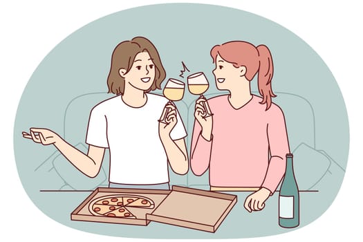 Happy girls eat pizza drink wine