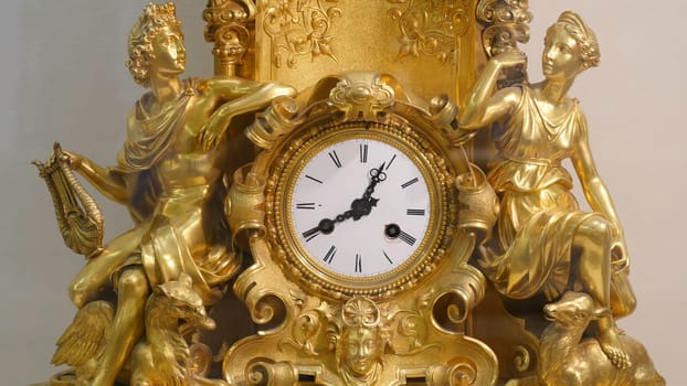Ancient vintage brass pendulum clock. Vintage gold watch
