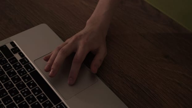 Close-up of hand on laptop mouse. Stock footage. Hand moves mouse on laptop panel. Touchpad of mouse on laptop