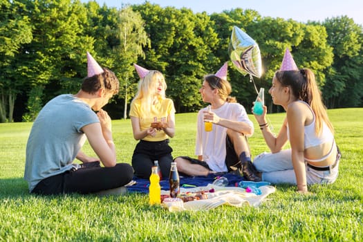 Teenage birthday party picnic on the grass in the park