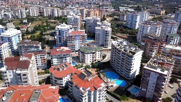 Top view of resort town with hotels. Clip. Numerous multi-storey hotels with swimming pools are located in southern resort town