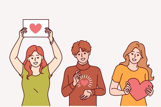 Hearts in people hands showing symbol gratitude and charity, calling for people to become volunteers. Guy and two teenage girls are participating in charity event or wishing you happy valentine day