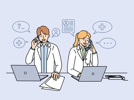Doctors work in clinic telephone helpline and answer patients questions by phone