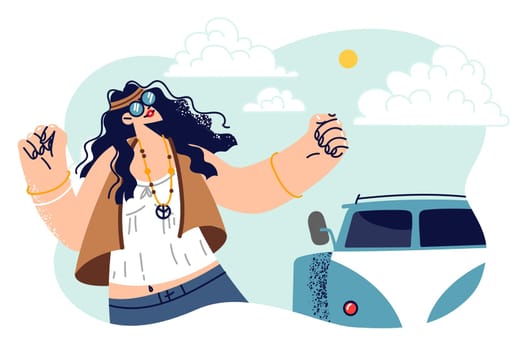Hippie woman dances standing near minivan and celebrates start of trip or summer vacation