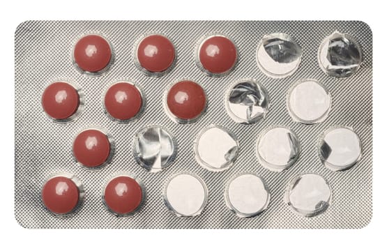 Round brown tablets in blister pack