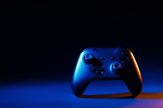 Gaming joystick on black background in neon light